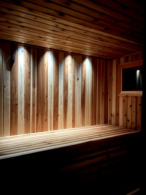Recessed Cariitti lighting glowing along the cedar ceiling and bench